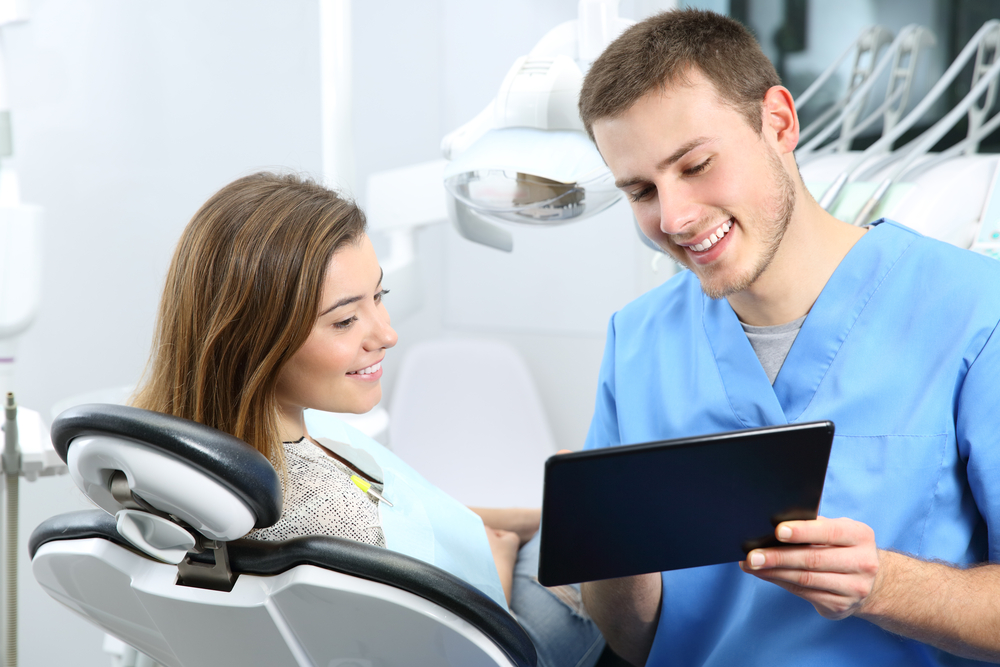 doctor and patient discussing dental crown cost in Southern Maryland