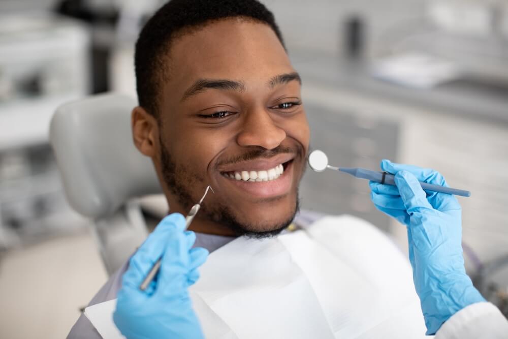 man smiling after getting affordable dental implants in Southern Maryland