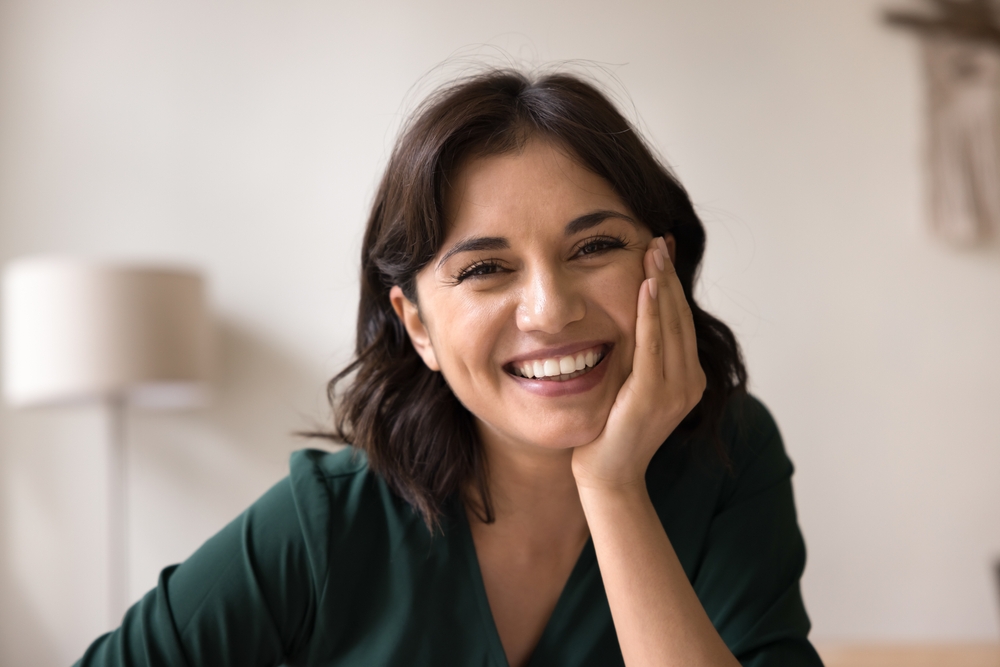 woman showing off the benefits of full-arch surgery in Calvert County