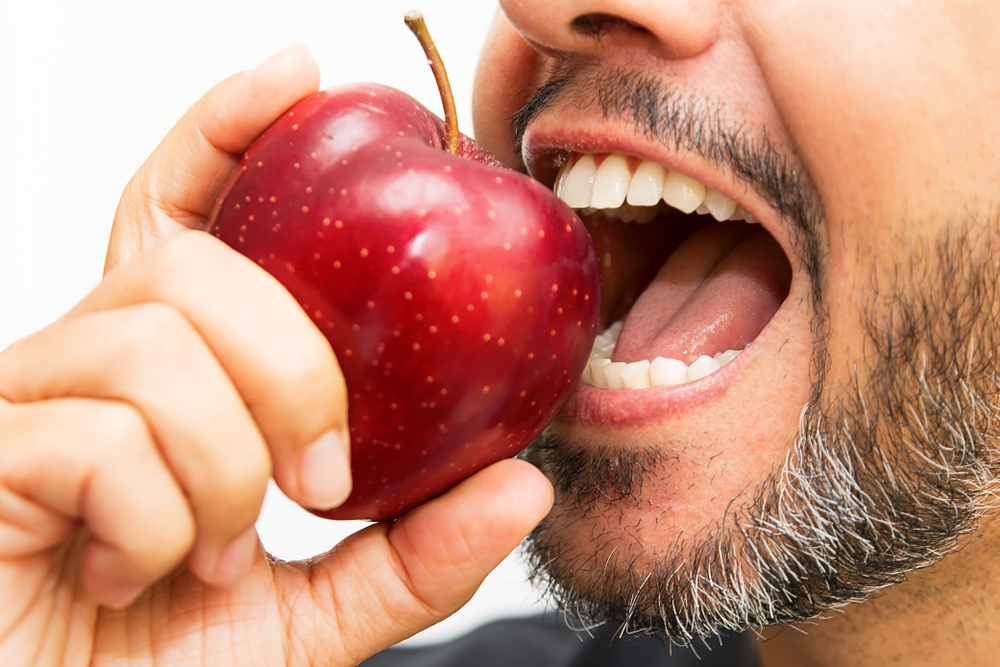 man having trouble eating with dentures in Calvert County