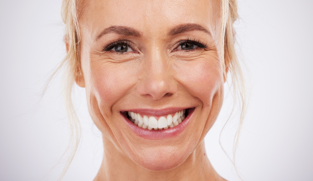 woman showing off her dental implants that last a lifetime