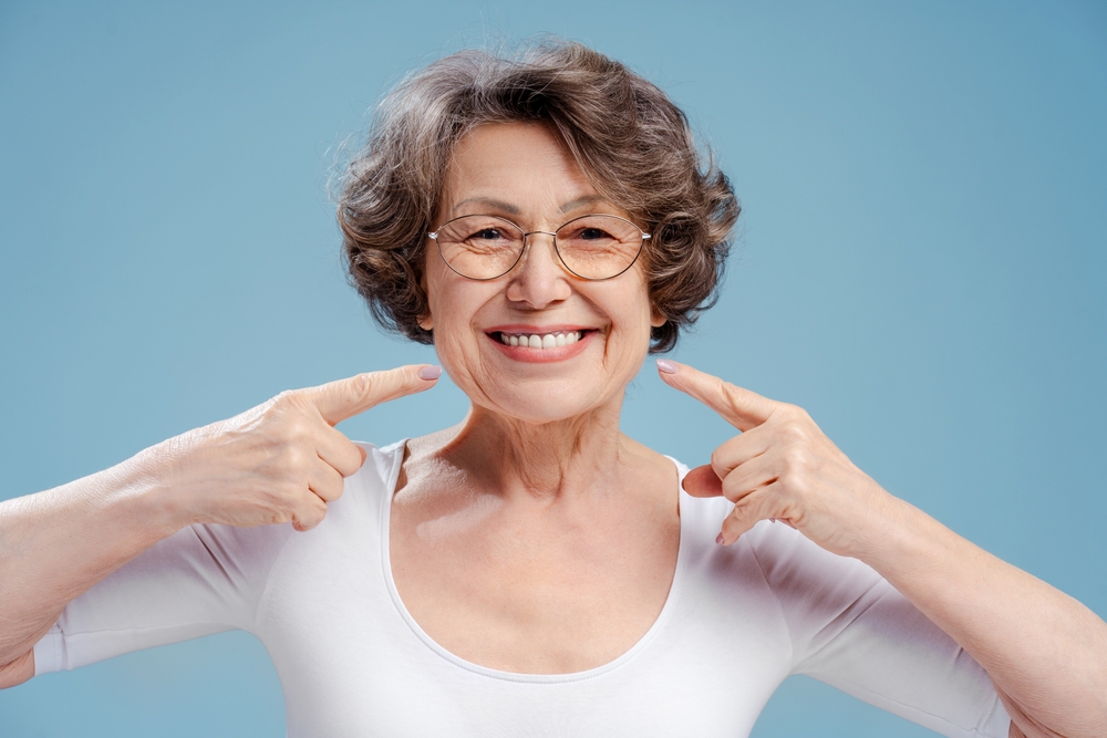 woman happy to recover from full arch surgery in MD